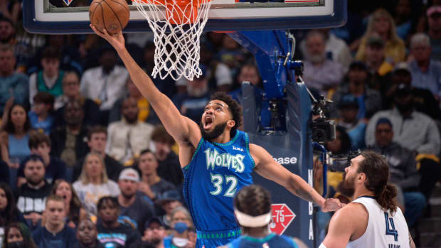 Minnesota Timberwolves center Karl-Anthony Towns (32) shoots ahead of Memphis Grizzlies center Steven Adams (4) during the first half of Game 1 of a first-round NBA basketball playoff series Saturday, April 16, 2022, in Memphis, Tenn. (AP Photo/Brandon Dill)