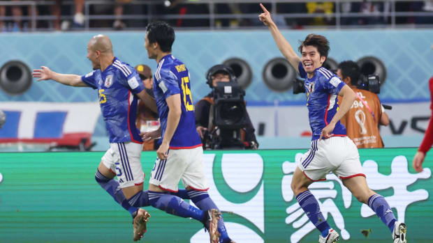 Japan celebrates a goal vs. Spain.