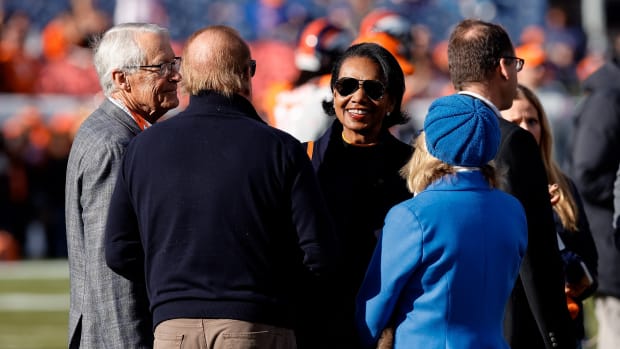 Denver Broncos owners Rob Walton (L) and former U.S. Secretary of State Condolezza Rice (R) talk with Los Angeles Chargers owner Dean Spanos and his wife Susie Spanos before the game at Empower Field at Mile High.